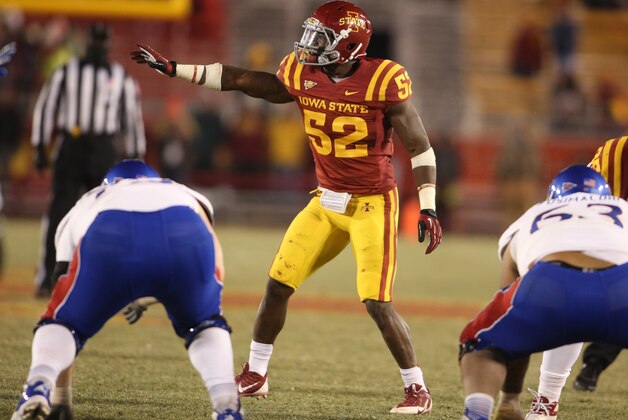 Iowa State linebacker Jeremiah George (52) gives directions to another Iowa State defensive player during the second half of an NCAA college football game against Kansas in Ames, Iowa, Saturday, Nov. 23, 2013. Iowa State won 34-0. (AP Photo/Justin Hayworth)