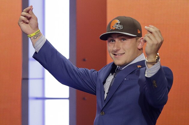 Texas A&M quarterback Johnny Manziel reacts after being selected by the Cleveland Browns as the 22nd pick in the first round of the 2014 NFL Draft, Thursday, May 8, 2014, in New York. (AP Photo/Frank Franklin II)