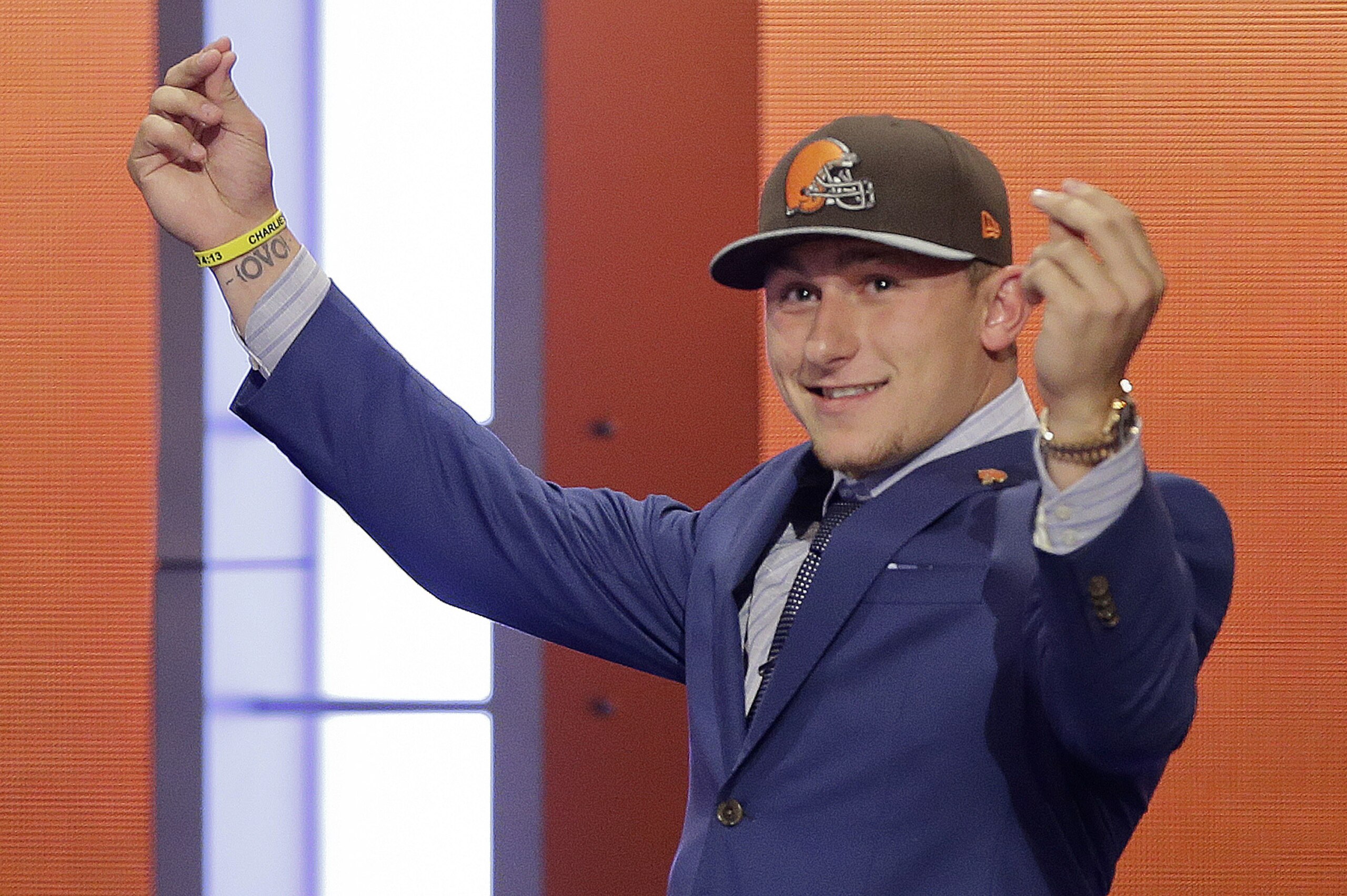 Texas A&M quarterback Johnny Manziel reacts after being selected by the Cleveland Browns as the 22nd pick in the first round of the 2014 NFL Draft, Thursday, May 8, 2014, in New York. (AP Photo/Frank Franklin II)