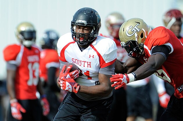 FAIRHOPE, AL - JANUARY 20:  Lorenzo Taliaferro #21 of the South team catches a pass in front of Jeremiah Attaochu #45 during a Senior Bowl practice session at Fairhope Stadium on January 20, 2014 in Fairhope, Alabama.  (Photo by Stacy Revere/Getty Images)