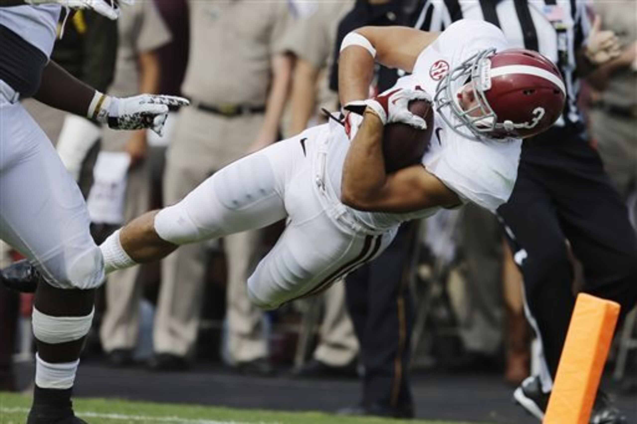 Alabama defensive back Vinnie Sunseri (3) dives over the goal line after returning a 73-yard interception from Texas A&M quarterback Johnny Manziel for a touchdown during the third quarter of an NCAA college football game Saturday, Sept. 14, 2013, in College Station, Texas. (AP Photo/David J. Phillip)