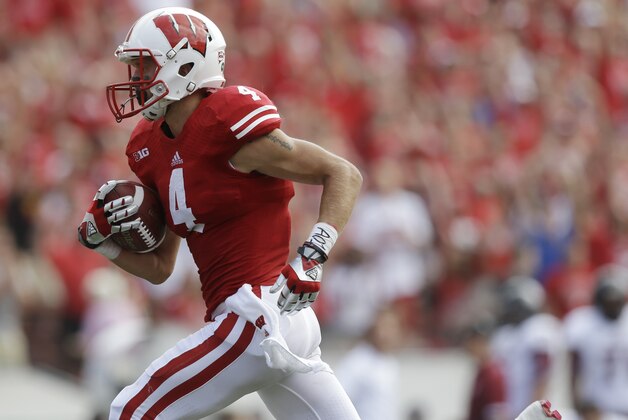 Wisconsin's Jared Abbrederis (4) catches a 65-yard touchdown pass during the second half of an NCAA college football game against Massachusetts Saturday, Aug. 31, 2013, in Madison, Wis. Wisconsin won 45-0. (AP Photo/Morry Gash)