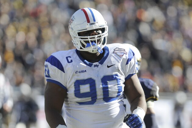 Middle Tennessee Blue Raiders defensive end Jimmy Staten (90) celebrates after making a tackle in the first half during the Armed Forces Bowl NCAA college football game against the Navy Midshipmen, Monday, Dec. 30, 2013, in Fort Worth. (AP Photo/Matt Strasen)