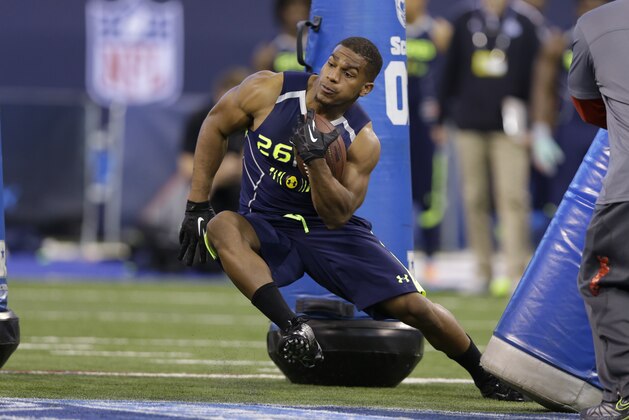 Washington running back Bishop Sankey runs a drill at the NFL football scouting combine in Indianapolis, Sunday, Feb. 23, 2014. (AP Photo/Michael Conroy)