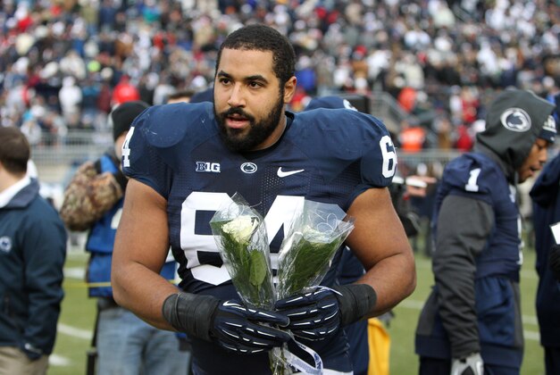 Nov 23, 2013; University Park, PA, USA; Penn State Nittany Lions guard John Urschel (64) walks onto the field during senior day recognition prior to the game against the Nebraska Cornhuskers at Beaver Stadium. Nebraska defeated Penn State 23-20 in overtime. Mandatory Credit: Matthew O'Haren-USA TODAY Sports