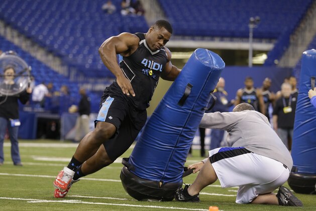Princeton defensive lineman Caraun Reid runs a drill at the NFL football scouting combine in Indianapolis, Monday, Feb. 24, 2014. (AP Photo/Michael Conroy)