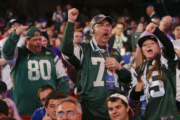 New York Jets fans react to the Jets' third round pick, Dexter McDougal of Maryland, during the 2014 NFL Draft, Friday, May 9, 2014, in New York. (AP Photo/Jason DeCrow)