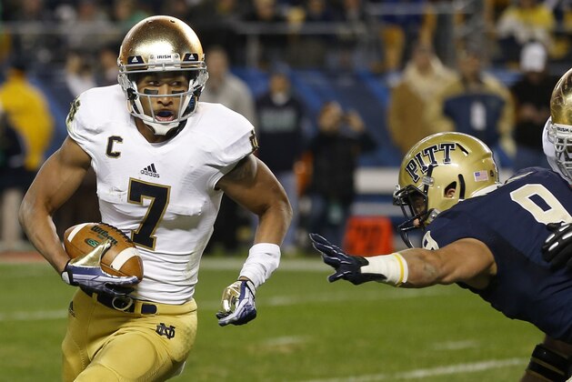 Notre Dame wide receiver TJ Jones (7) runs the ball past Pittsburgh defensive back Ray Vinopal (9) on his way to a touchdown in the second quarter of an NCAA college football game Saturday, Nov. 9, 2013, in Pittsburgh. (AP Photo/Keith Srakocic)