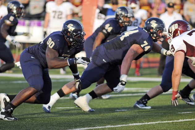 In this provided by Concordia University, St. Paul,  Concordia defensive back Zach Moore (90) rushes during an NCAA Division II football game in St. Paul, Minn. Moore never got the chance to become a household name in college. NFL scouts found him anyway. playing Division II football.  (AP Photo/Concordia University, St. Paul, Justin Oakman)