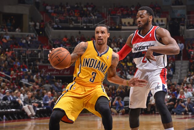 WASHINGTON, DC - MAY 09: George Hill #3 of the Indiana Pacers dribbles the ball against John Wall #2 of the Washington Wizards during Game Three of the Eastern Conference Semifinals at Verizon Center on May 9, 2014 in Washington, DC. NOTE TO USER: User expressly acknowledges and agrees that, by downloading and or using this photograph, User is consenting to the terms and conditions of the Getty Images License Agreement. Mandatory Copyright Notice: Copyright 2014 NBAE  (Photo by David Dow/NBAE via Getty Images)