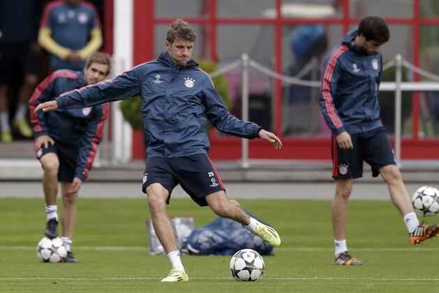Bayern's Thomas Mueller kicks a ball during a last training session in Munich, southern Germany, Tuesday, April 8, 2014. Bayern Munich will play Manchester United in a Champions League quarter final second leg soccer match on Wednesday. (AP Photo/Matthias Schrader)
