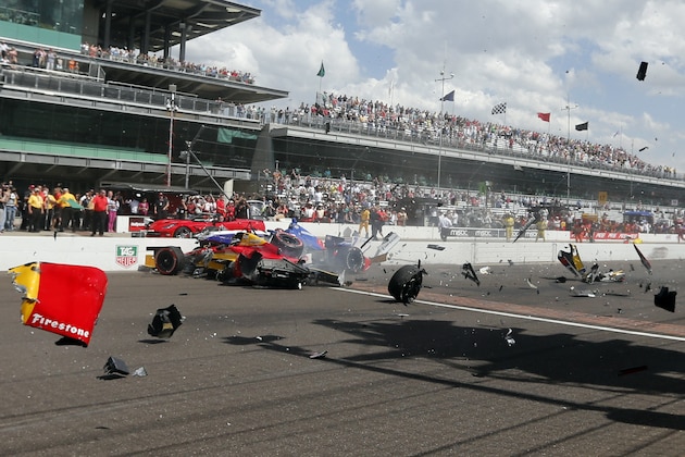 Sebastian Saavedra, left, of Colombia,  is hit by Mikhail Aleshin, of Russia,  at the start of the inaugural Grand Prix of Indianapolis IndyCar auto race at the Indianapolis Motor Speedway in Indianapolis, Saturday, May 10, 2014. (AP Photo/Robert Baker)