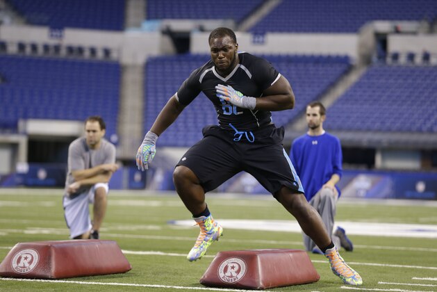 Louisiana Tech defensive lineman IK Enemkpali runs a drill at the NFL football scouting combine in Indianapolis, Monday, Feb. 24, 2014. (AP Photo/Michael Conroy)
