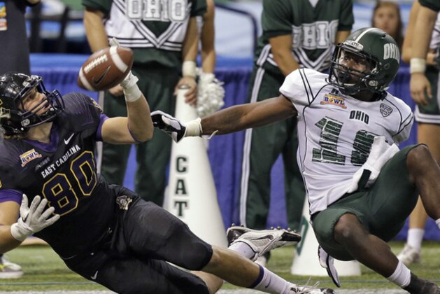 Ohio cornerback Travis Carrie (18) is called for pass interference on a pass to East Carolina wide receiver Bryce Williams (80) during the fourth quarter of the Beef 'O' Brady's Bowl NCAA college football game on Monday, Dec. 23, 2013, in St. Petersburg, Fla. East Carolina won the game 37-20. (AP Photo/Chris O'Meara)