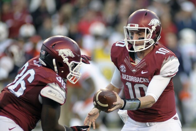 Arkansas quarterback Brandon Allen (10) hands off to fullback Kiero Small (36) in the first half of an NCAA college football game in Fayetteville, Ark., Saturday, Nov. 2, 2013. (AP Photo/Beth Hall)