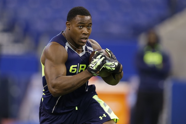 Arizona running back Ka'Deem Carey runs a drill at the NFL football scouting combine in Indianapolis, Sunday, Feb. 23, 2014. (AP Photo/Michael Conroy)