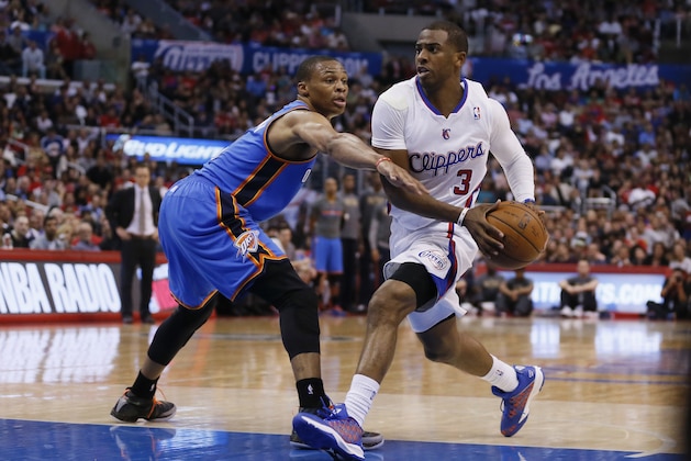 Los Angeles Clippers guard Chris Paul, right, drives past Oklahoma City Thunder guard Russell Westbrook during the first half of an NBA basketball game in Los Angeles, Wednesday, April 9, 2014. (AP Photo/Danny Moloshok)