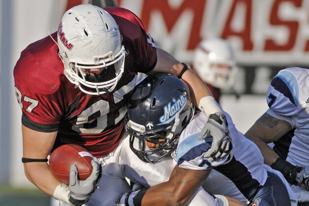 Massachusetts' Rob Blanchflower,left, gets tackled on a run by Maine's Trevor Coston in the first half of an NCAA college football game in Amherst, Mass. Saturday, Nov. 6, 2010. (AP Photo/Nancy Palmieri)