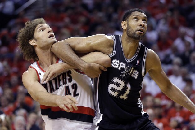 Portland Trail Blazers' Robin Lopez (42) and San Antonio Spurs' Tim Duncan (21) battle for position under the boards in the second quarter during Game 3 of a Western Conference semifinal NBA basketball playoff series Saturday, May 10, 2014, in Portland, Ore. (AP Photo/Rick Bowmer)