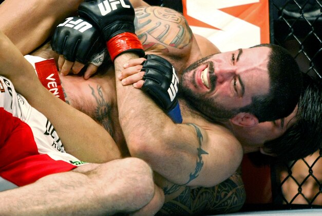 May 10, 2014; Cincinnati, OH, USA; Matt Brown (red gloves) fights Erick Silva (blue gloves) during a welterweight bout at US Bank Arena. Mandatory Credit: Joe Maiorana-USA TODAY Sports