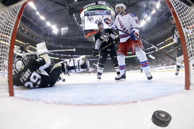 In this photo taken with a fisheye lens, goal by New York Rangers' Derick Brassard (not shown) gets past Pittsburgh Penguins goalie Marc-Andre Fleury (29) in the second period of Game 5 of a second-round NHL playoff hockey series in Pittsburgh, Friday, May 9, 2014. It was Brassard's second goal of the game. The Rangers won 5-1. (AP Photo/Gene J. Puskar)