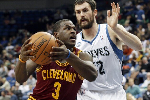 Cleveland Cavaliers' Dion Waiters, left, drives around Minnesota Timberwolves' Kevin Love in the second half of an NBA basketball game Wednesday, Nov. 13, 2013, in Minneapolis. The Timberwolves won 124-95. (AP Photo/Jim Mone)