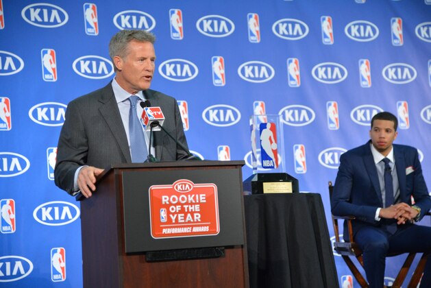 PHILADELPHIA, PA - MAY 5: Head Coach Brett Brown speaks to the media as Michael Carter-Williams of the Philadelphia 76ers receives the Eddie Gottlieb Trophy for the 2013-14 Kia NBA Rookie of the Year at the Philadelphia College of Osteopathic Medicine on May 5, 2014 in Philadelphia, Pennsylvania. NOTE TO USER: User expressly acknowledges and agrees that, by downloading and or using this photograph, User is consenting to the terms and conditions of the Getty Images License Agreement. Mandatory Copyright Notice: Copyright 2014 NBAE (Photo by Jesse D. Garrabrant/NBAE via Getty Images)