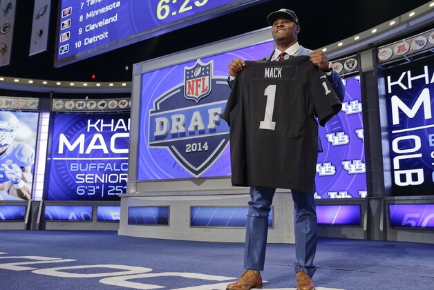 Buffalo linebacker Khalil Mack, right, poses for photos with NFL commissioner Roger Goodell after being selected by the Oakland Raiders as the fifth pick in the first round of the 2014 NFL Draft, Thursday, May 8, 2014, in New York. (AP Photo/Craig Ruttle) . (AP Photo/Craig Ruttle)