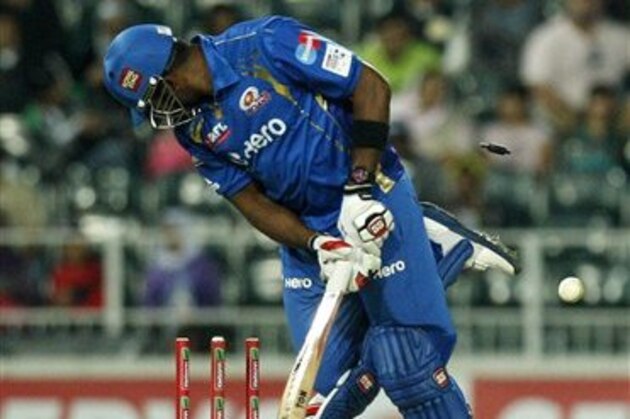 Mumbai Indians batsman Kieron Pollard is bowled by Highveld Lions Sohail Tanveer, unseen, for 11 runs during the Champions League Twenty20 cricket match at the Wanderers Stadium, Johannesburg, South Africa, Sunday, Oct. 14, 2012. (AP Photo/ Themba Hadebe)