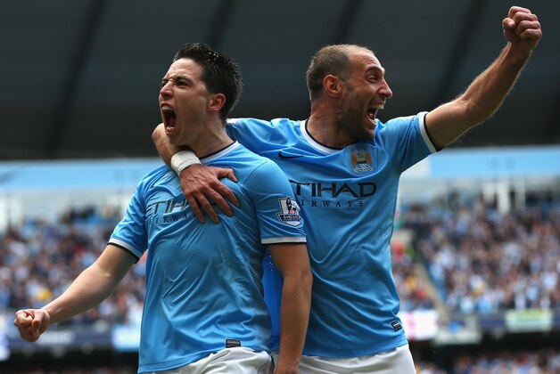 MANCHESTER, ENGLAND - MAY 11:  Samir Nasri of Manchester City celebrates scoring the first goal with team-mate Pablo Zabaleta (R) during the Barclays Premier League match between Manchester City and West Ham United at the Etihad Stadium on May 11, 2014 in Manchester, England.  (Photo by Alex Livesey/Getty Images)