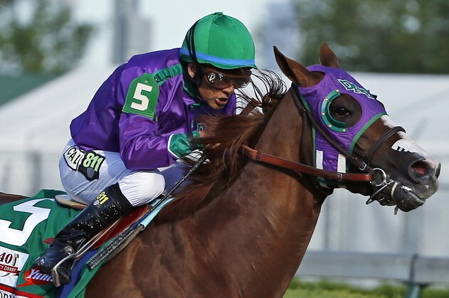 FILE - In this May 3, 2014, file photo, jockey Victor Espinoza rides California Chrome to win the 140th running of the Kentucky Derby horse race at Churchill Downs in Louisville, Ky. The California colt will be running in the Preakness with a bulls-eye on his back as perhaps racing's next superstar. He figures to face eight or nine rivals in the middle leg of the Triple Crown series, and one of them might be a filly.  (AP Photo/Matt Slocum, File)