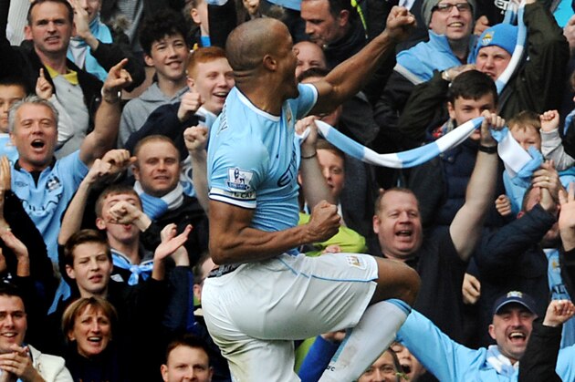 Manchester City's Vincent Kompany celebrates with fans after scoring against West Ham during the English Premier League soccer match between Manchester City and West Ham United at the Etihad Stadium,  Manchester, England, Sunday, May 11, 2014. (AP Photo/Rui Vieira)