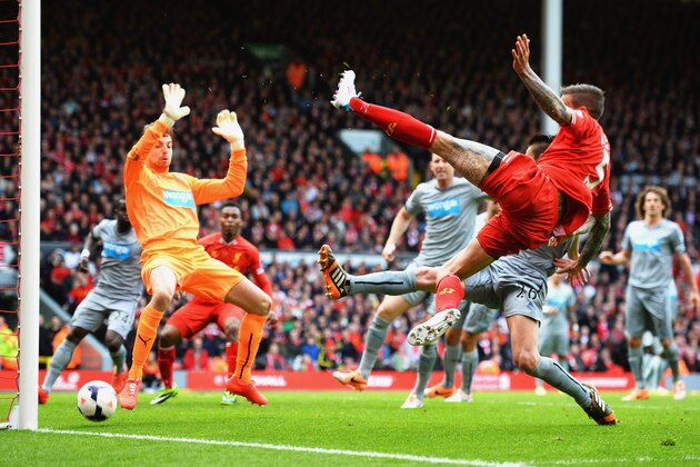 LIVERPOOL, ENGLAND - MAY 11:  Daniel Agger of Liverpool (5) shoots past Tim Krul of Newcastle United to score their first goal during the Barclays Premier League match between Liverpool and Newcastle United at Anfield on May 11, 2014 in Liverpool, England.  (Photo by Laurence Griffiths/Getty Images)