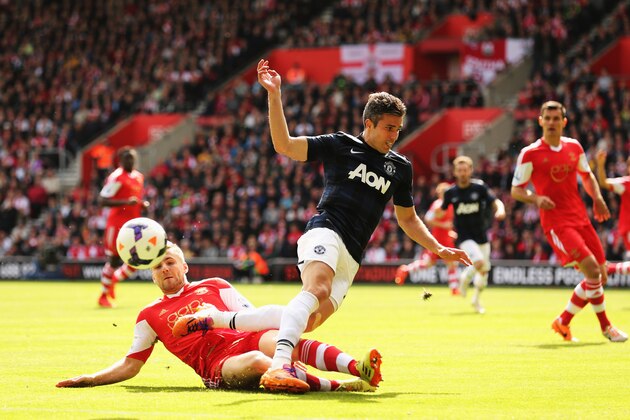 SOUTHAMPTON, ENGLAND - MAY 11:  Robin van Persie (R) of Manchester United is tackled by Luke Shaw (L) of Southampton during the Barclays Premier League match between Southampton and Manchester United at St Mary's Stadium on May 11, 2014 in Southampton, England.  (Photo by Ian Walton/Getty Images)