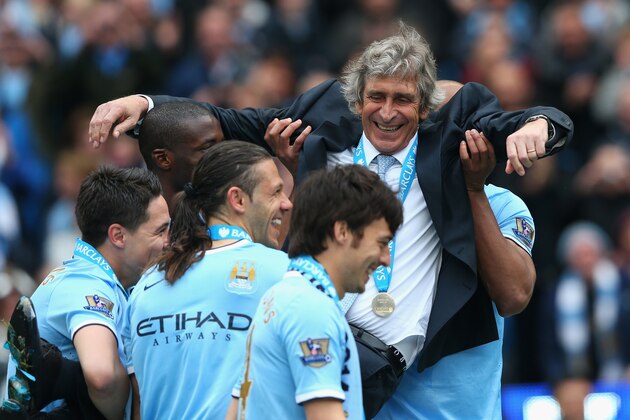 MANCHESTER, ENGLAND - MAY 11:  The Manchester City Manager Manuel Pellegrini is lifted up by the players to throw him in the air at the end of the Barclays Premier League match between Manchester City and West Ham United at the Etihad Stadium on May 11, 2014 in Manchester, England.  (Photo by Alex Livesey/Getty Images)