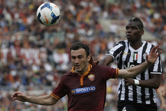 Roma defender Vasilis Torosidis, of Greece, left, and Juventus midfielder Paul Pogba, of France, vie for the ball during an Italian Serie A soccer match between Roma and Juventus at Rome's Olympic stadium, Sunday, May 11, 2014. (AP Photo/Alessandra Tarantino)