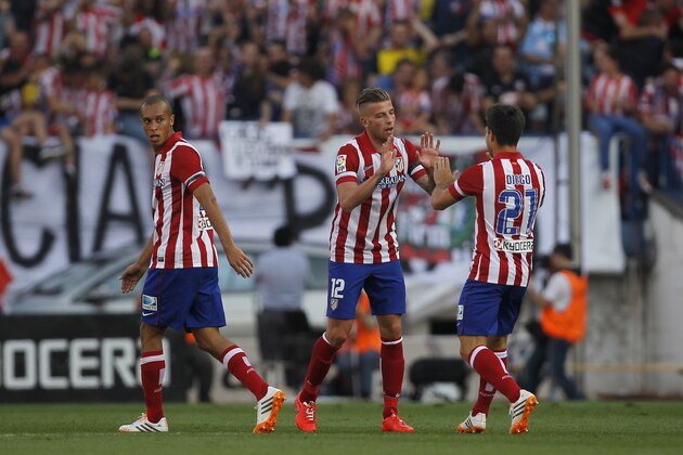 Atletico's Toby Alderweireld, center, celebrates his goal with teammates during a Spanish La Liga soccer match between Atletico Madrid and Malaga at the Vicente Calderon stadium in Madrid, Spain, Sunday May 11, 2014. (AP Photo/Gabriel Pecot)