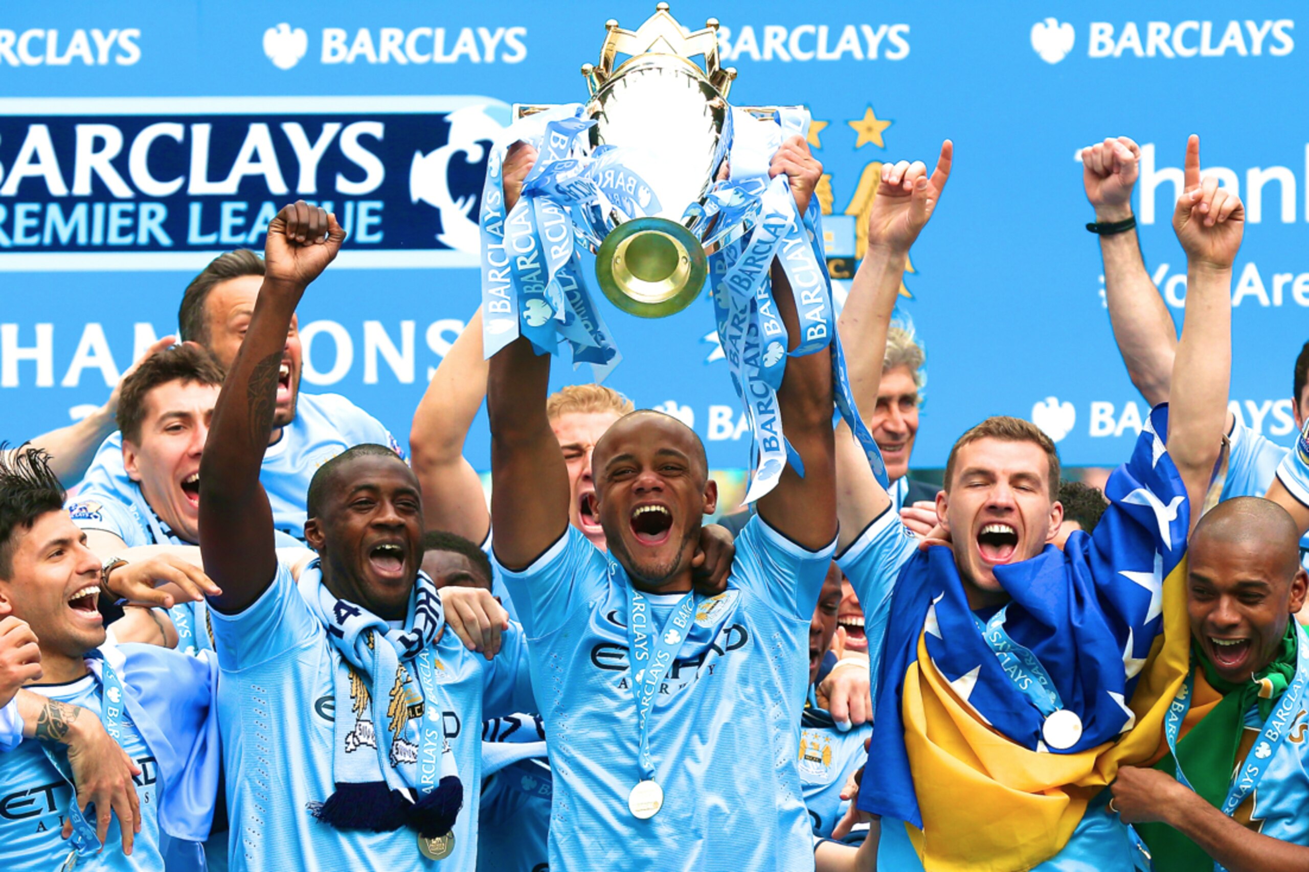 Manchester City's manager Manuel Pellegrini poses for photographers with the trophy after the English Premier League soccer match between Manchester City and West Ham at the Etihad Stadium in Manchester, England, Sunday May 11, 2014.  Manchester City won the Premier League for the second time in three seasons on Sunday, completing its campaign with a comfortable 2-0 victory over West Ham that lacked any of the drama of its previous title.  (AP Photo/Jon Super)