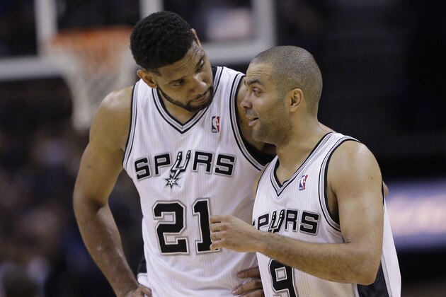San Antonio Spurs' Tim Duncan (21) and Tony Parker (9) walk of the court during the second half of Game 7 of the opening-round NBA basketball playoff series against the Dallas Mavericks, Sunday, May 4, 2014, in San Antonio. San Antonio won 119-96. (AP Photo/Eric Gay)