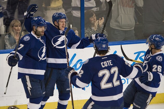 Tampa Bay Lightning's Radko Gudas (7), Jean-Philippe Cote (22) and Martin St. Louis (26) celebrate with Ondrej Palat after his goal against the New York Rangers during the first period of an NHL hockey game, Sunday, Dec. 29, 2013, in Tampa, Fla. (AP Photo/Steve Nesius)
