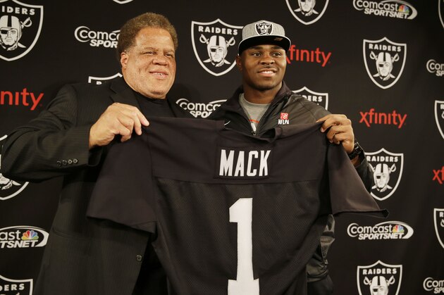 Oakland Raiders first-round draft choice Khalil Mack, right, poses with general manager Reggie McKenzie, left, following a news conference at the team's NFL football headquarters on Friday, May 9, 2014, in Alameda, Calif. Mack, a linebacker, played for Buffalo last season. (AP Photo/Eric Risberg)