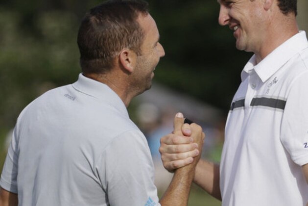 Sergio Garcia of Spain, left, and Justin Rose of England, thanks each other at the end of the third round of The Players championship golf tournament at TPC Sawgrass, Saturday, May 10, 2014 in Ponte Vedra Beach, Fla. (AP Photo/Lynne Sladky)