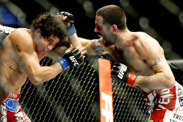 May 10, 2014; Cincinnati, OH, USA; Matt Brown (red gloves) fights Erick Silva (blue gloves) during a welterweight bout at US Bank Arena. Mandatory Credit: Joe Maiorana-USA TODAY Sports