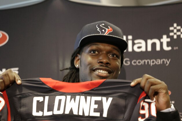 Houston Texans No. 1 overall draft pick Jadeveon Clowney, a defensive end from South Carolina, holds up his new jersey during an introductory NFL football news conference Friday, May 9, 2014, in Houston. (AP Photo/Pat Sullivan)