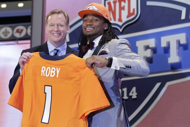 Ohio State cornerback Bradley Roby poses with NFL commissioner Roger Goodell after being selected by the Denver Broncos as the 31st pick in the first round of the 2014 NFL Draft, Thursday, May 8, 2014, in New York.  (AP Photo/Craig Ruttle)