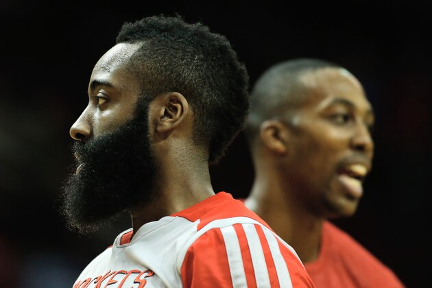 HOUSTON, TX - JANUARY 24:  James Harden #13 and Dwight Howard #12 of the Houston Rockets wait on the court before the game against the Memphis Grizzlies at the Toyota Center on January 24, 2014 in Houston, Texas. NOTE TO USER: User expressly acknowledges and agrees that, by downloading and or using this photograph, User is consenting to the terms and conditions of the Getty Images License Agreement. (Photo by Scott Halleran/Getty Images)