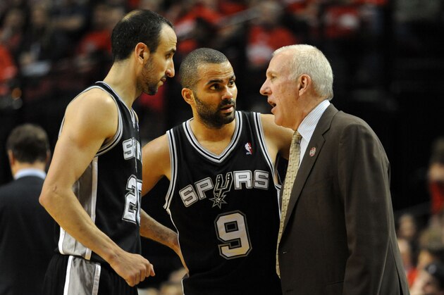 PORTLAND, OR - MAY 10: Gregg Popovich of the San Antonio Spurs speaks with Manu Ginobili #20 and Tony Parker #9 of the San Antonio Spurs in the second half of Game Three of the Western Conference Semifinals against the Portland Trail Blazers during the 2014 NBA Playoffs at the Moda Center on May 10, 2014 in Portland, Oregon. The Spurs won the game 118-103. NOTE TO USER: User expressly acknowledges and agrees that, by downloading and or using this photograph, User is consenting to the terms and conditions of the Getty Images License Agreement. (Photo by Steve Dykes/Getty Images)