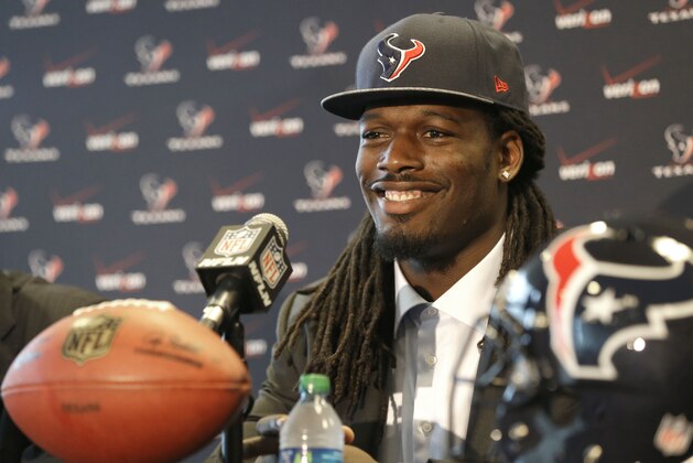 Houston Texans No. 1 overall NFL draft pick defensive end Jadeveon Clowney smiles during an introductory NFL football news conference Friday, May 9, 2014, in Houston. (AP Photo/Pat Sullivan)