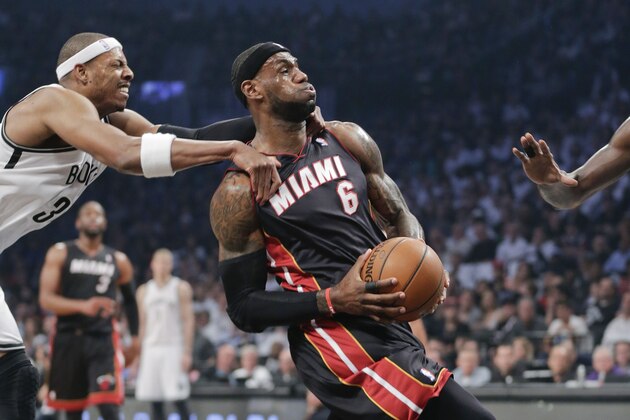 Brooklyn Nets forward Paul Pierce (34) fouls Miami Heat forward LeBron James (6) who drives through the lane to score in the first period during Game 3 of an Eastern Conference semifinal NBA playoff basketball game, Saturday, May 10, 2014, in New York. Pierce was called for a flagrant foul and James scored on the play. (AP Photo/Julie Jacobson)