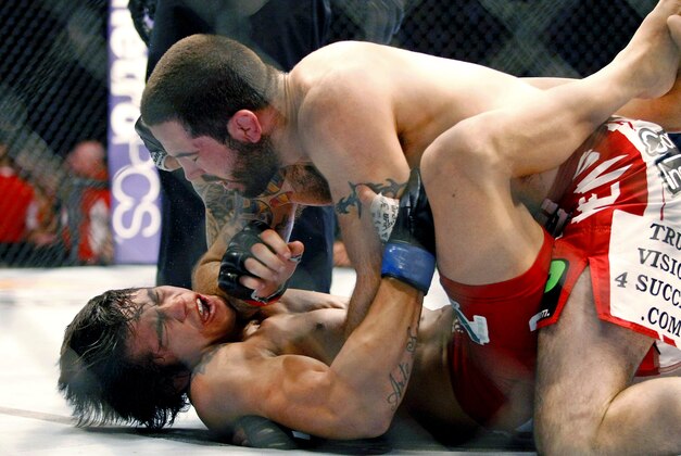 May 10, 2014; Cincinnati, OH, USA; Matt Brown (red gloves) fights Erick Silva (blue gloves) during a welterweight bout at US Bank Arena. Mandatory Credit: Joe Maiorana-USA TODAY Sports